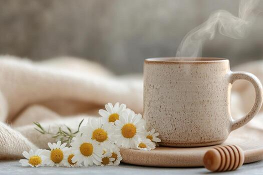 A warm ceramic cup of herbal tea surrounded by dried chamomile flowers and fresh mint leaves on a wooden surface