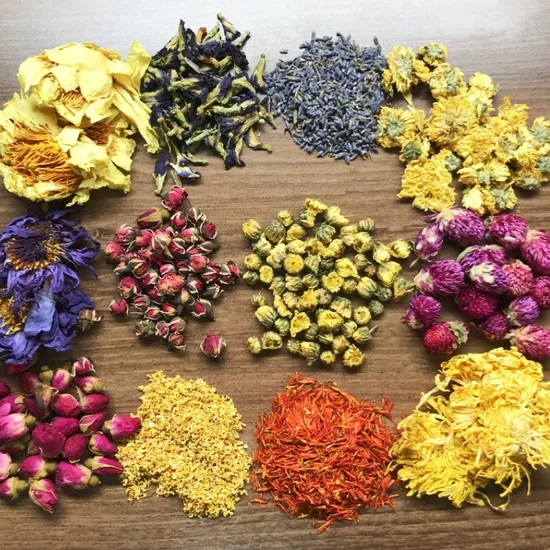 An assortment of dried herbs including lavender, chamomile, rosehip, and peppermint arranged on a light linen surface